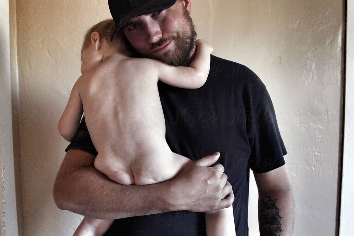 Proud Father Holding His Naked Child