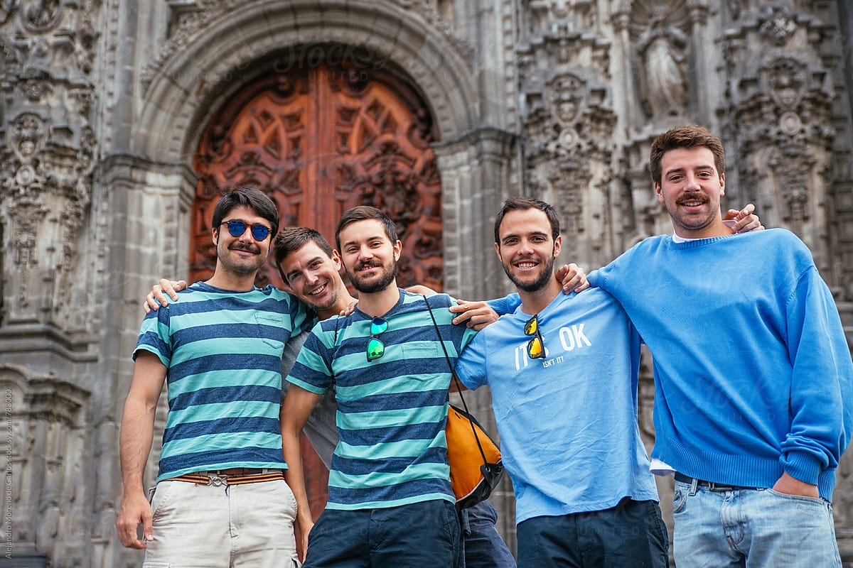 Group of young friends smiling in front of a cathedral