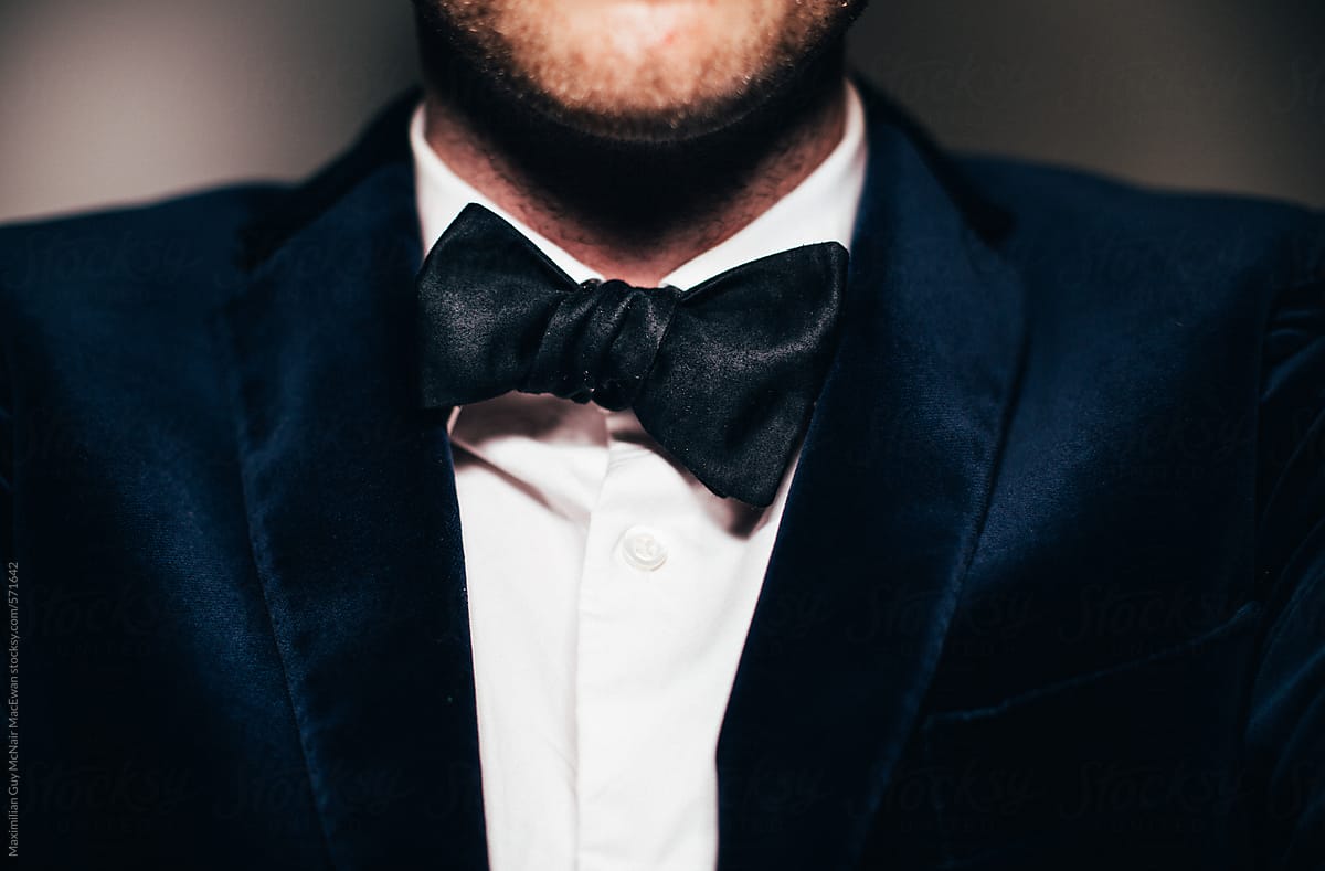 Close up of a man wearing a suit and bow tie