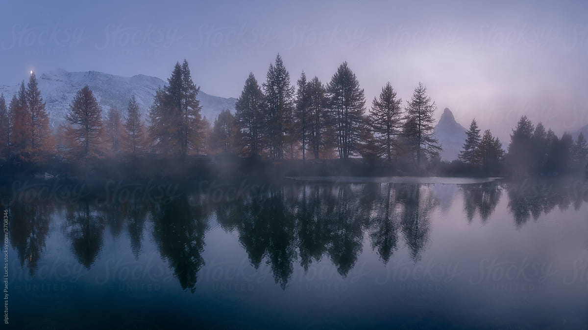 Foggy lake, forest and Matterhorn