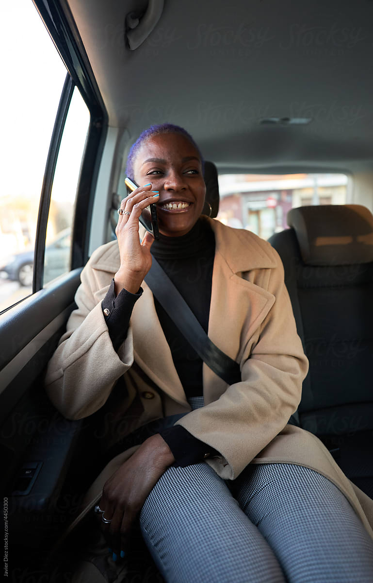 Female entrepreneur using smartphone in car