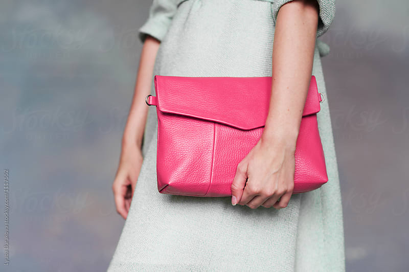 Woman holding pink bag