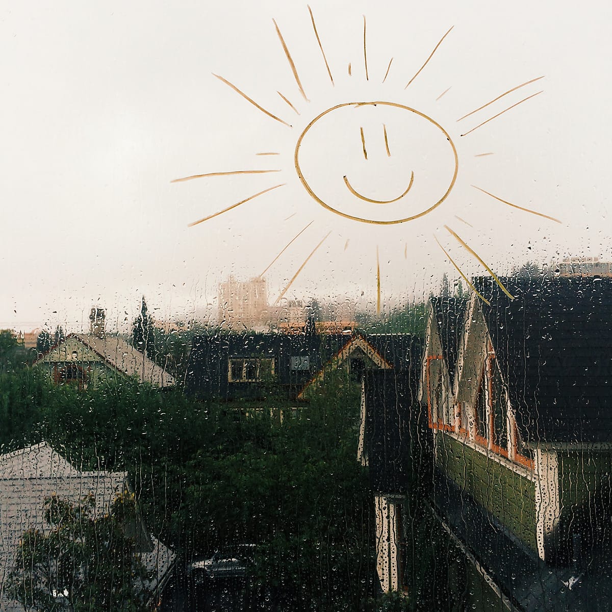 Sunshine Drawn on Rain Covered Window