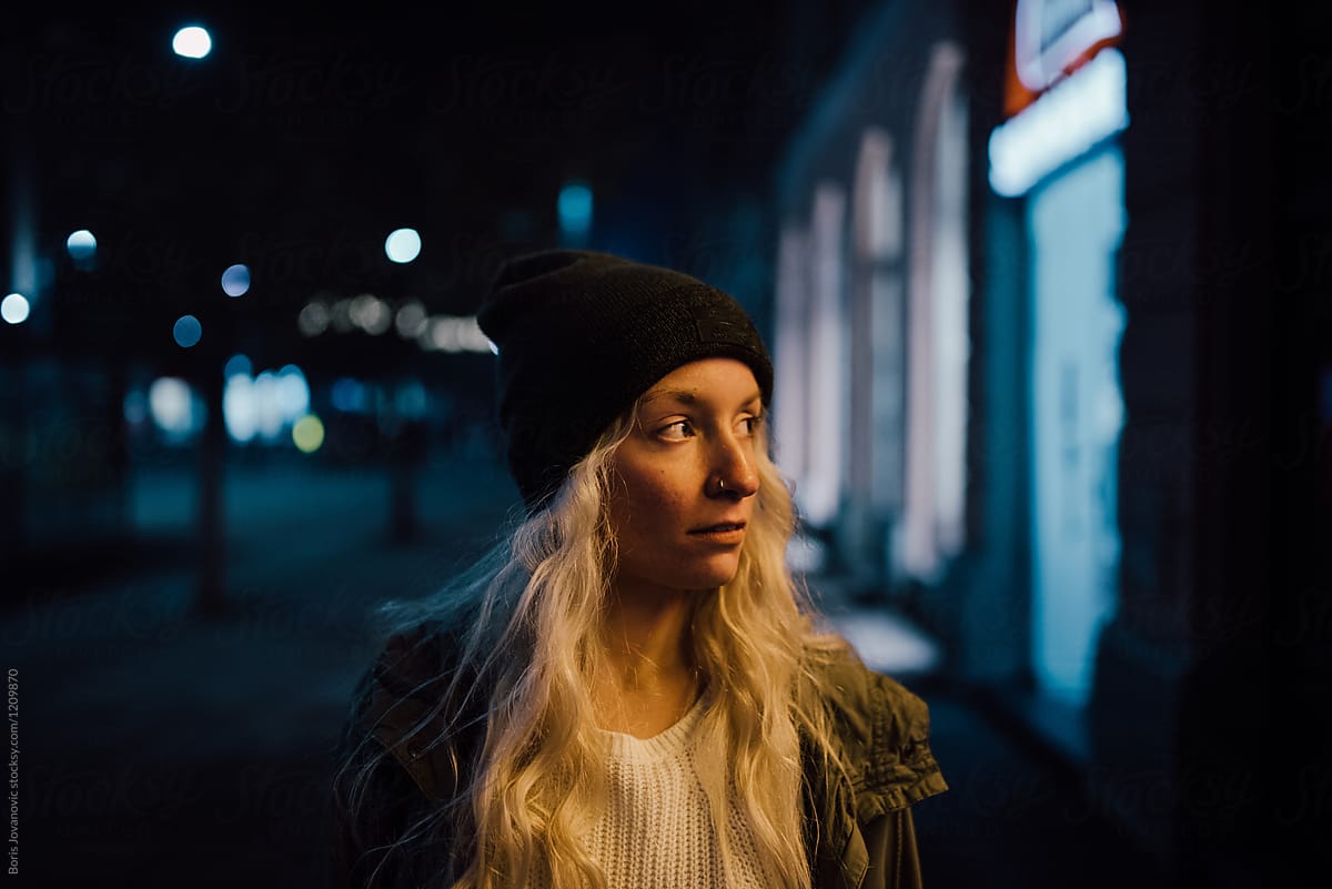 Portrait of a beautiful blonde woman at night outdoors