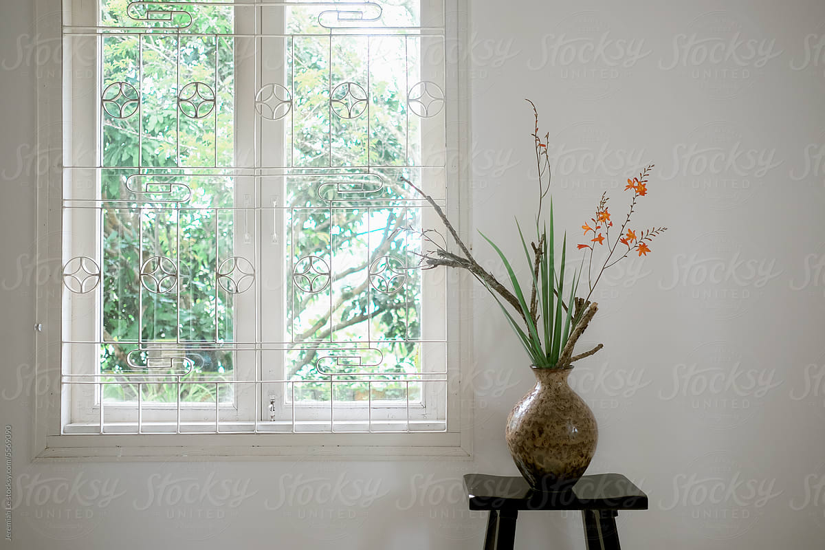 Minimal flower vase beside the window