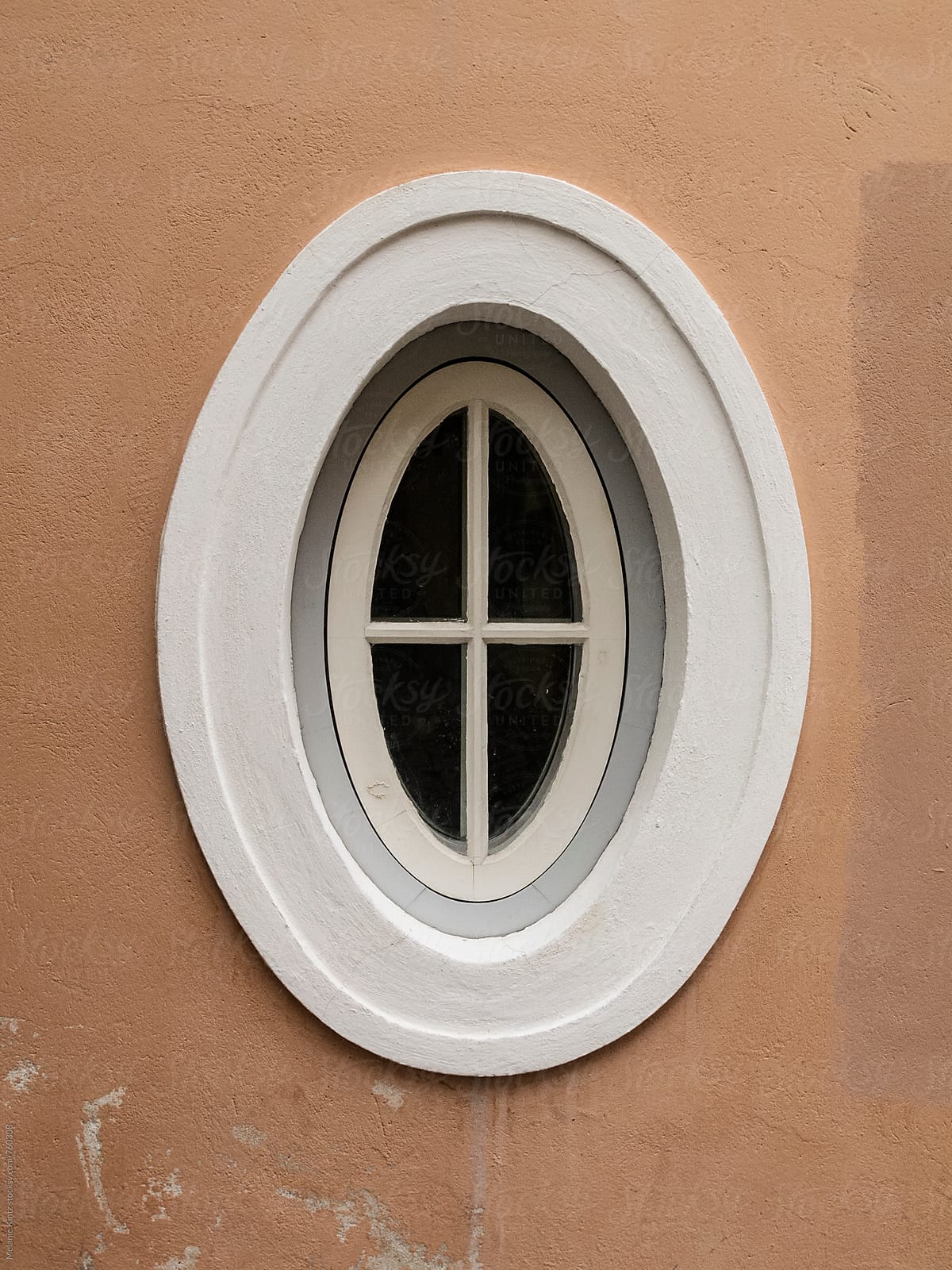 Oval window in brown wall
