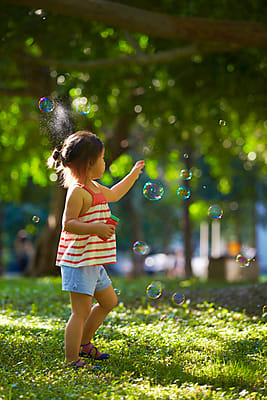 Two happy little asian kids playing outdoor in the sunny park Stock Photo -  Alamy