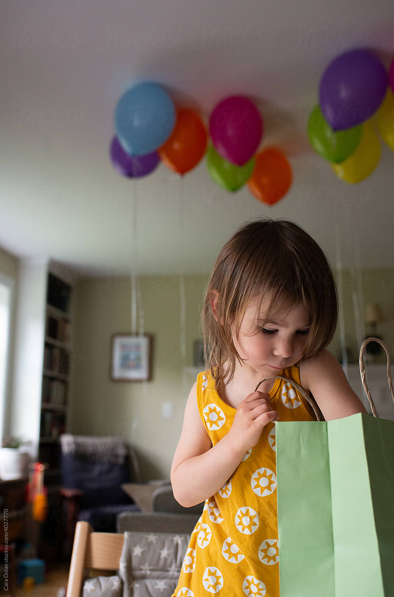 3 Year Old Reaches into Bag to see Birthday Surprise