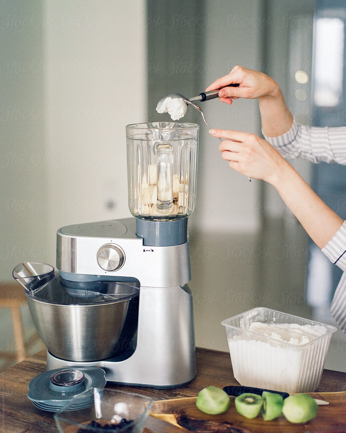 Person putting ice cream to blender