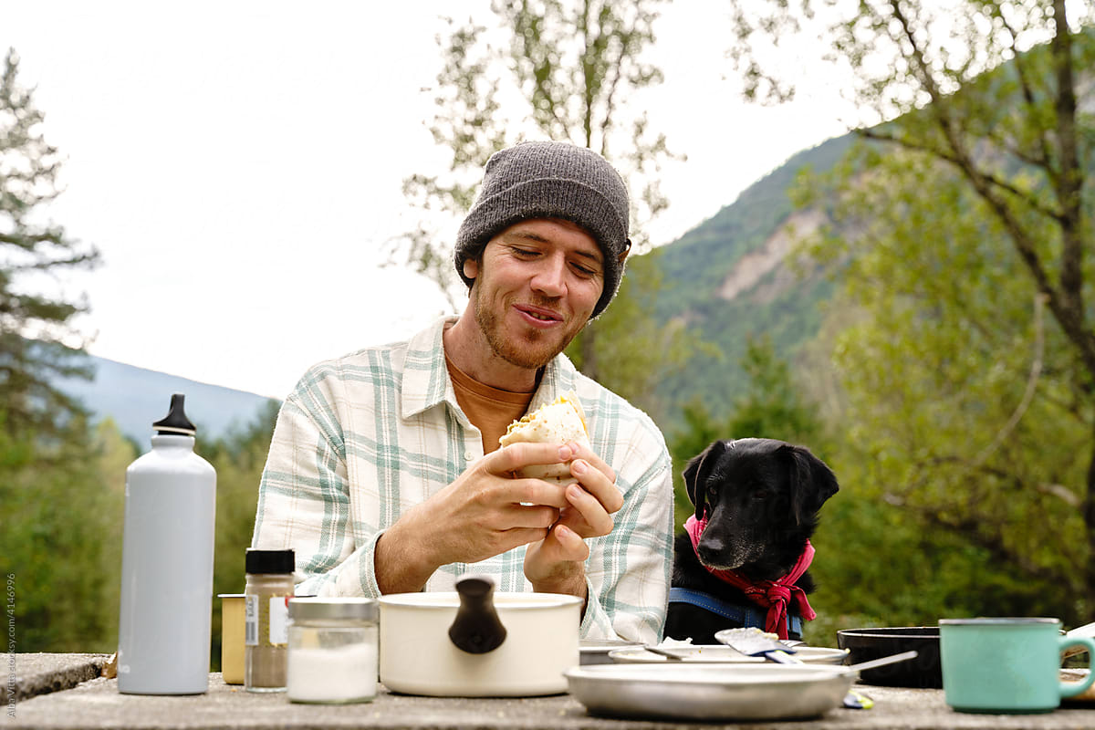 Smiley Man having picnic outdoors with his dog