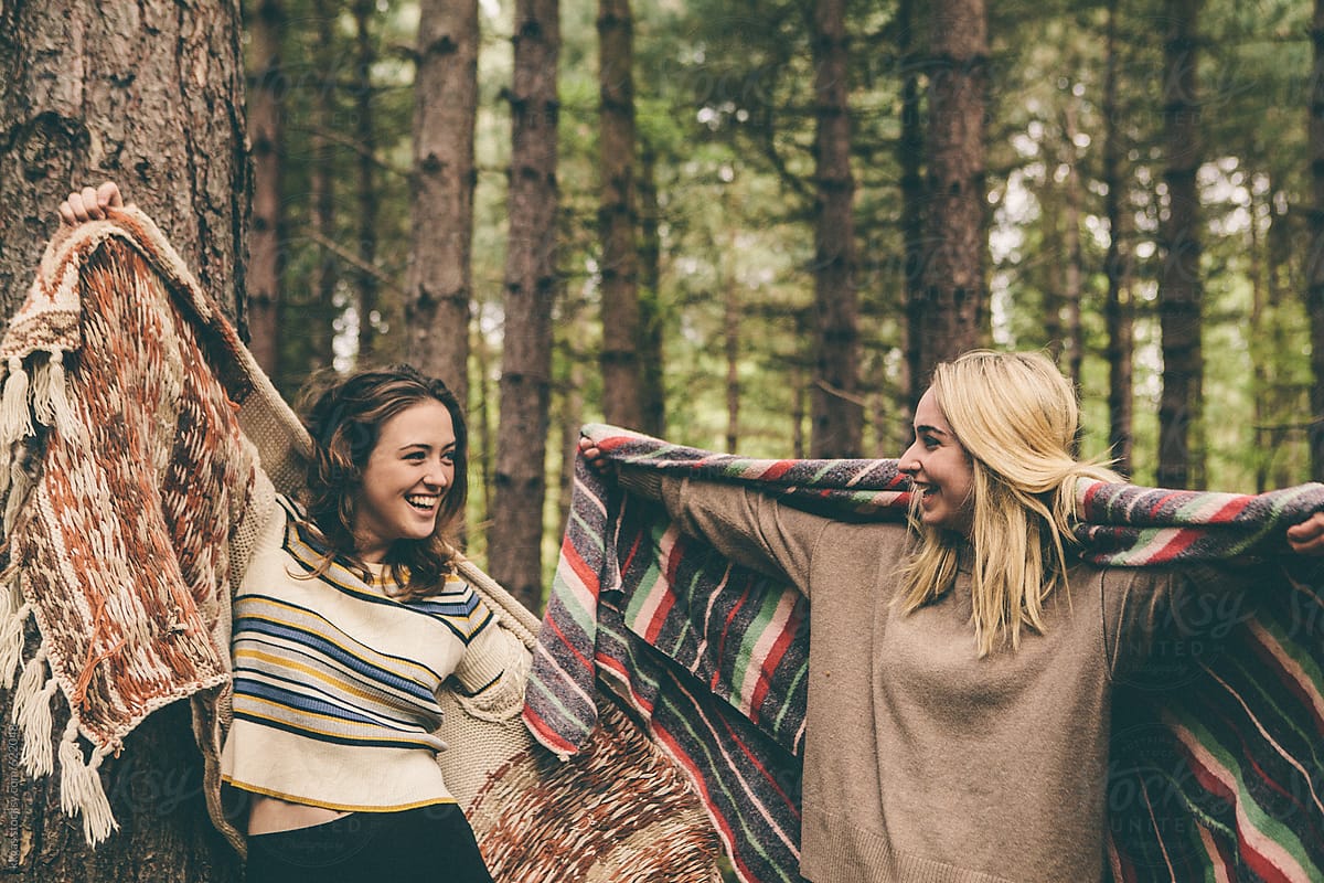 Two Teenage Girls Having Fun In A Forest Del Colaborador De Stocksy