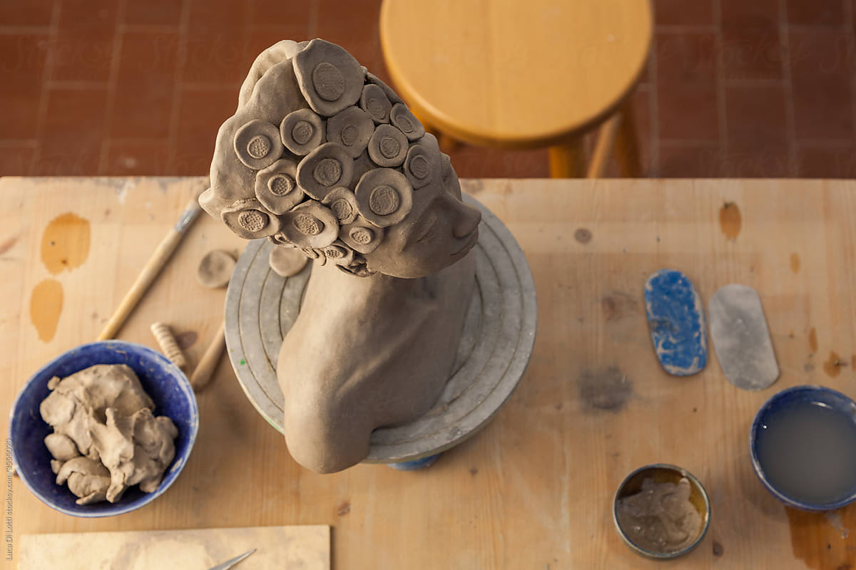 statue on a pottery artist\'s workbench