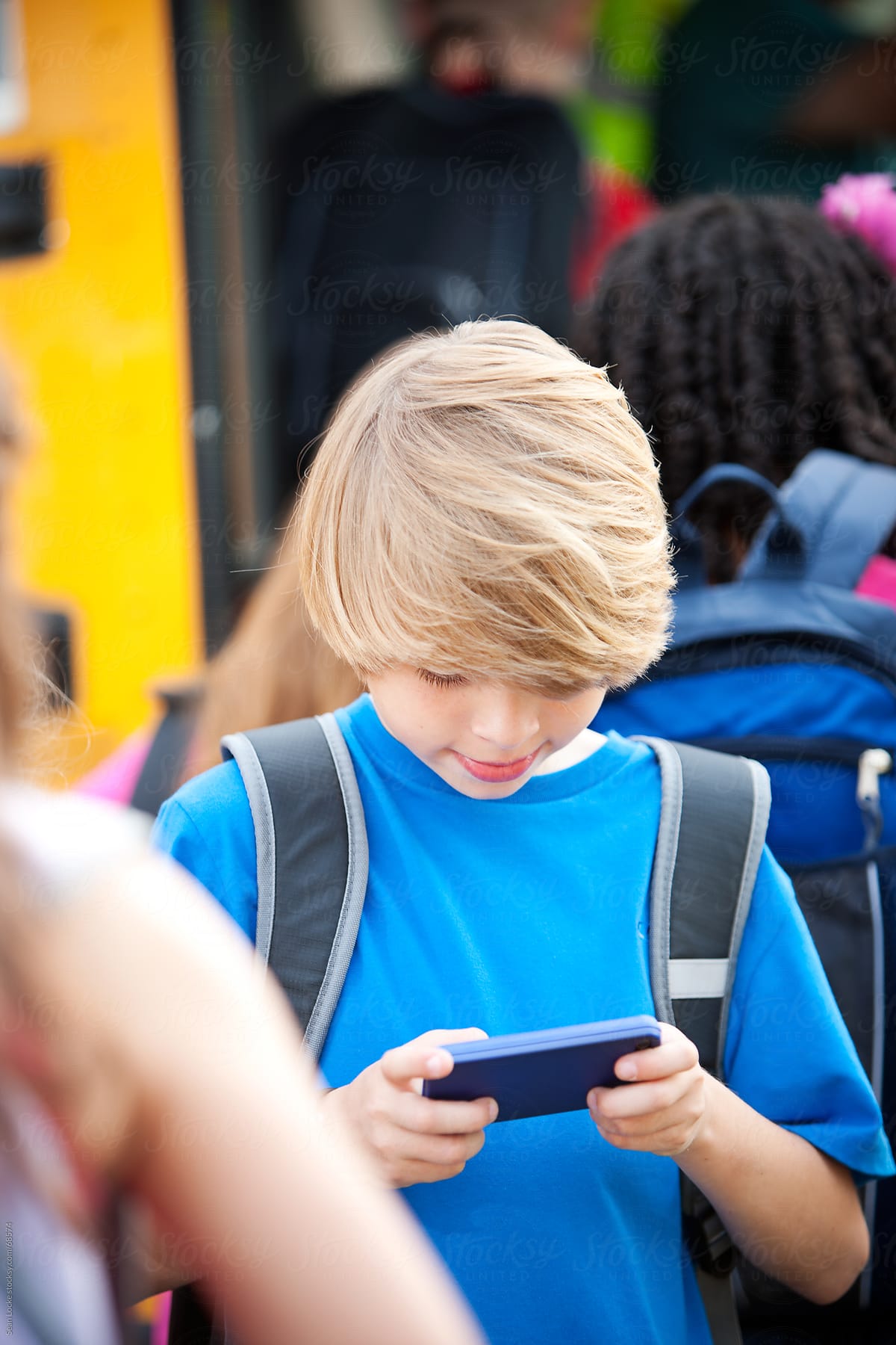 School Bus: Boy Checks Texts on Cell Phone