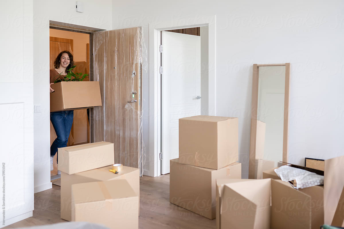 Woman Moving In To New Apartment