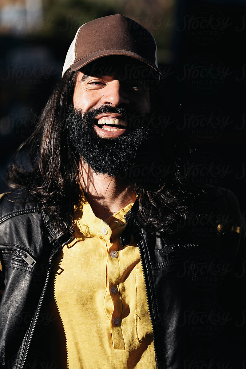Bearded cheerful man in cap