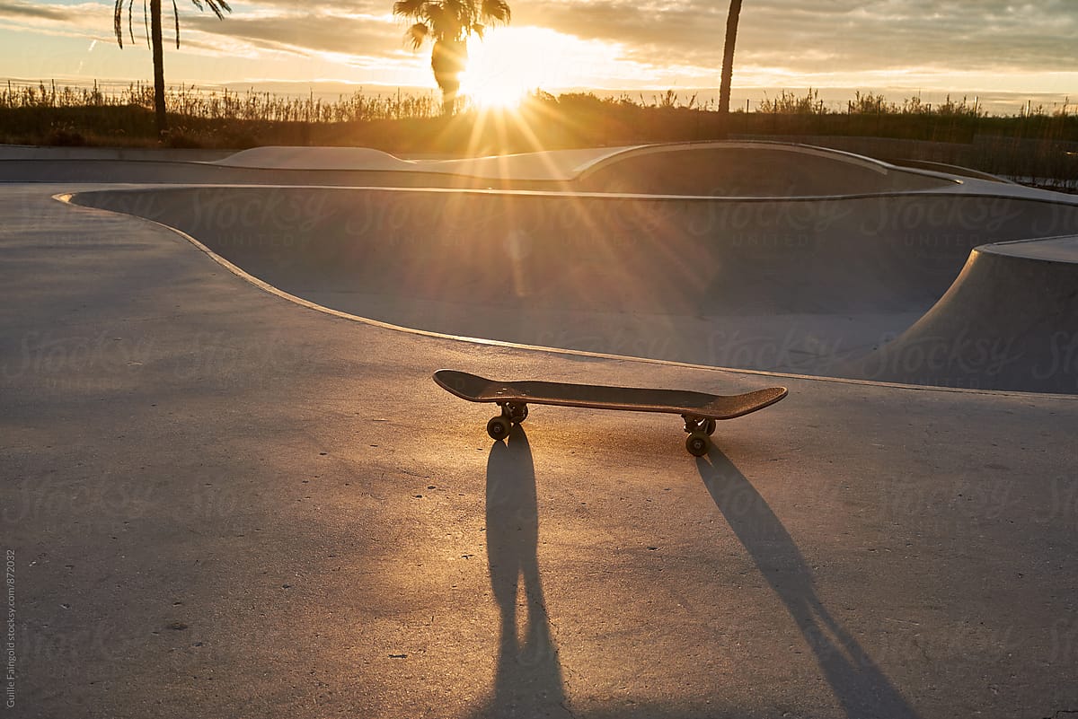 Skateboard in skate park at sundown