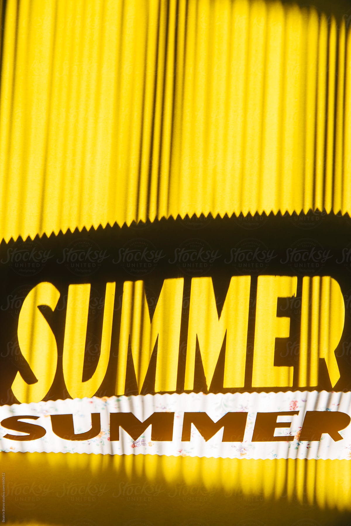 Word summer reflected on a yellow background, made with a handmade stencil