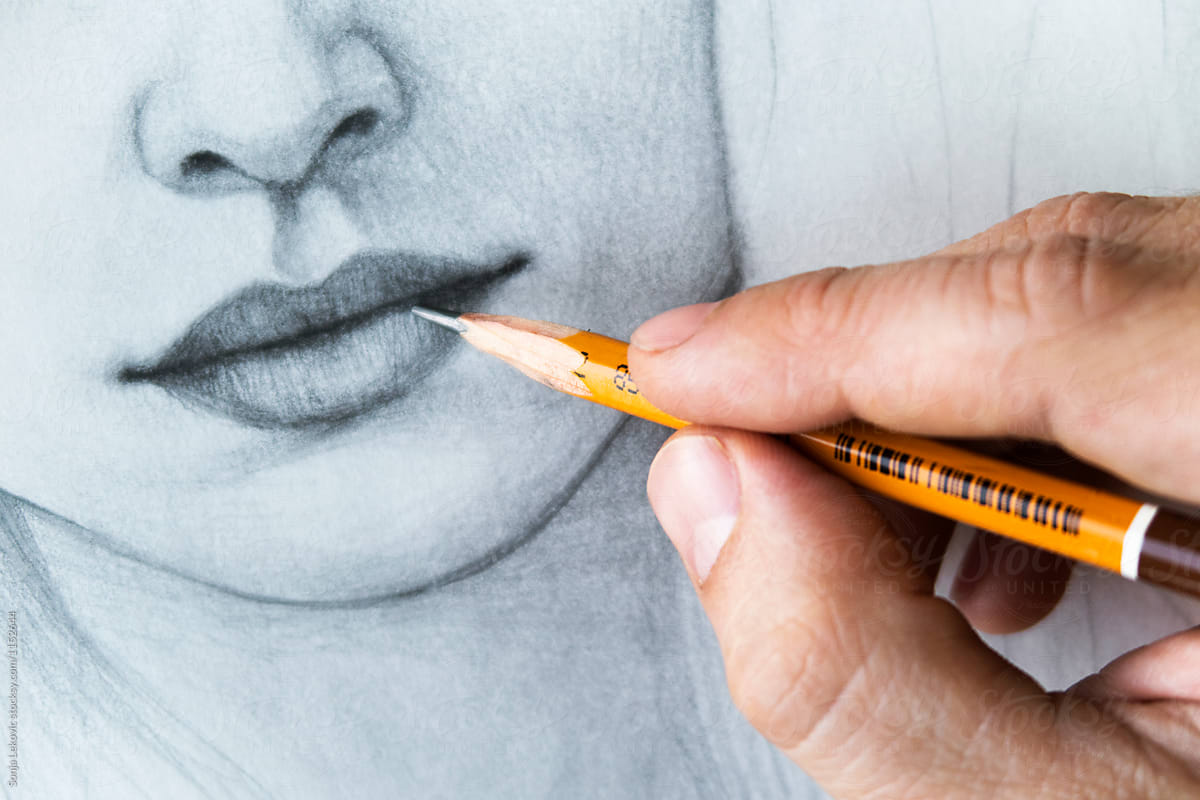 hand drawing lips with a pencil closeup