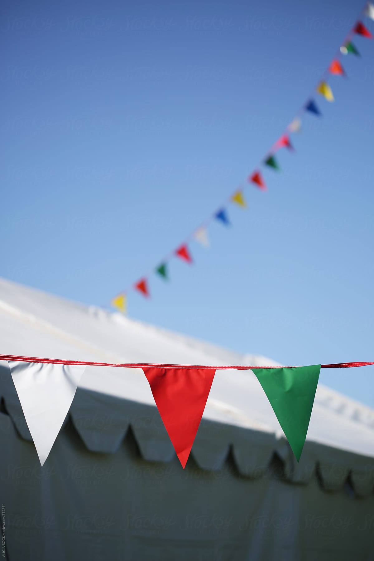 Festive Flags Hanging Outside A Party Tent On A Clear Summer Day