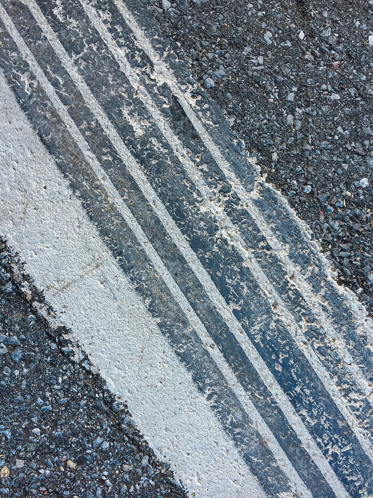 Close of tire tracks on speed bump along urban street
