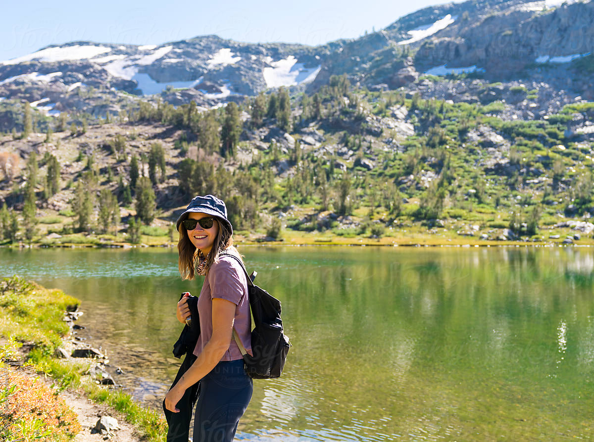woman on trail by a lake