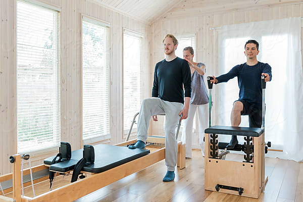 Woman Performing Pilates Exercise Using A Cadillac Or Trapeze Table by  Stocksy Contributor Paul Phillips - Stocksy