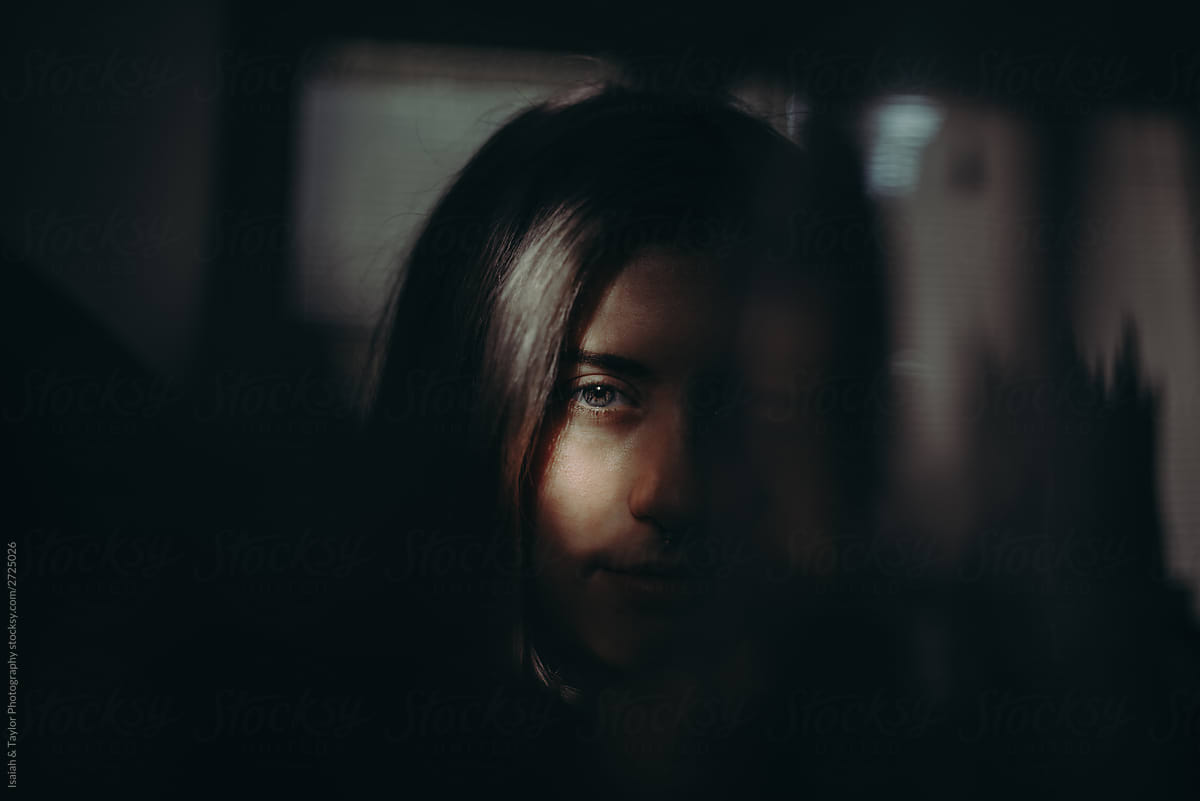 Dramatic portrait of young woman looking at camera with a serious face