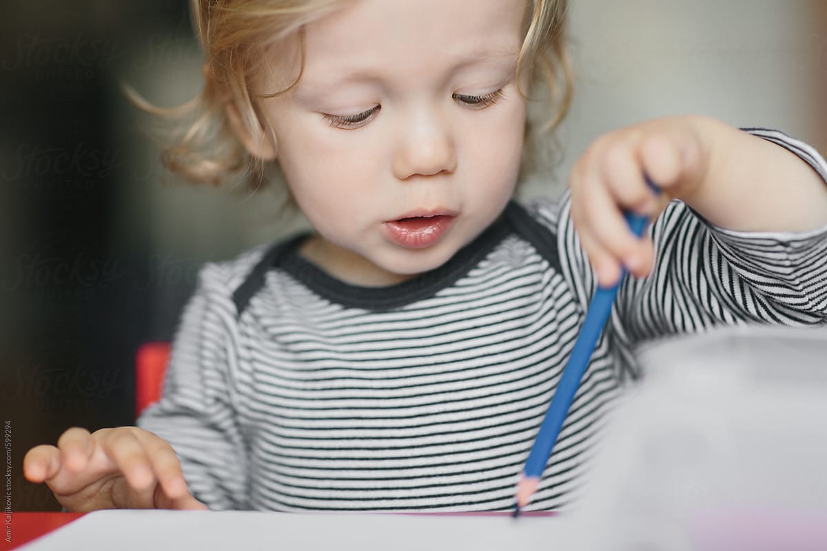 Cute little boy trying to learn to draw