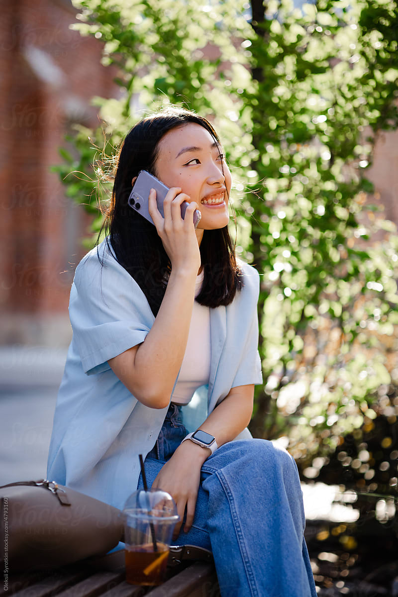 Woman talking by phone on open air