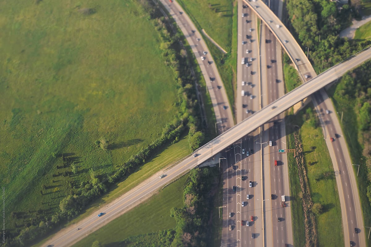 Bird\'s Eye view of cars traveling on a highway, as seen from an airplane.
