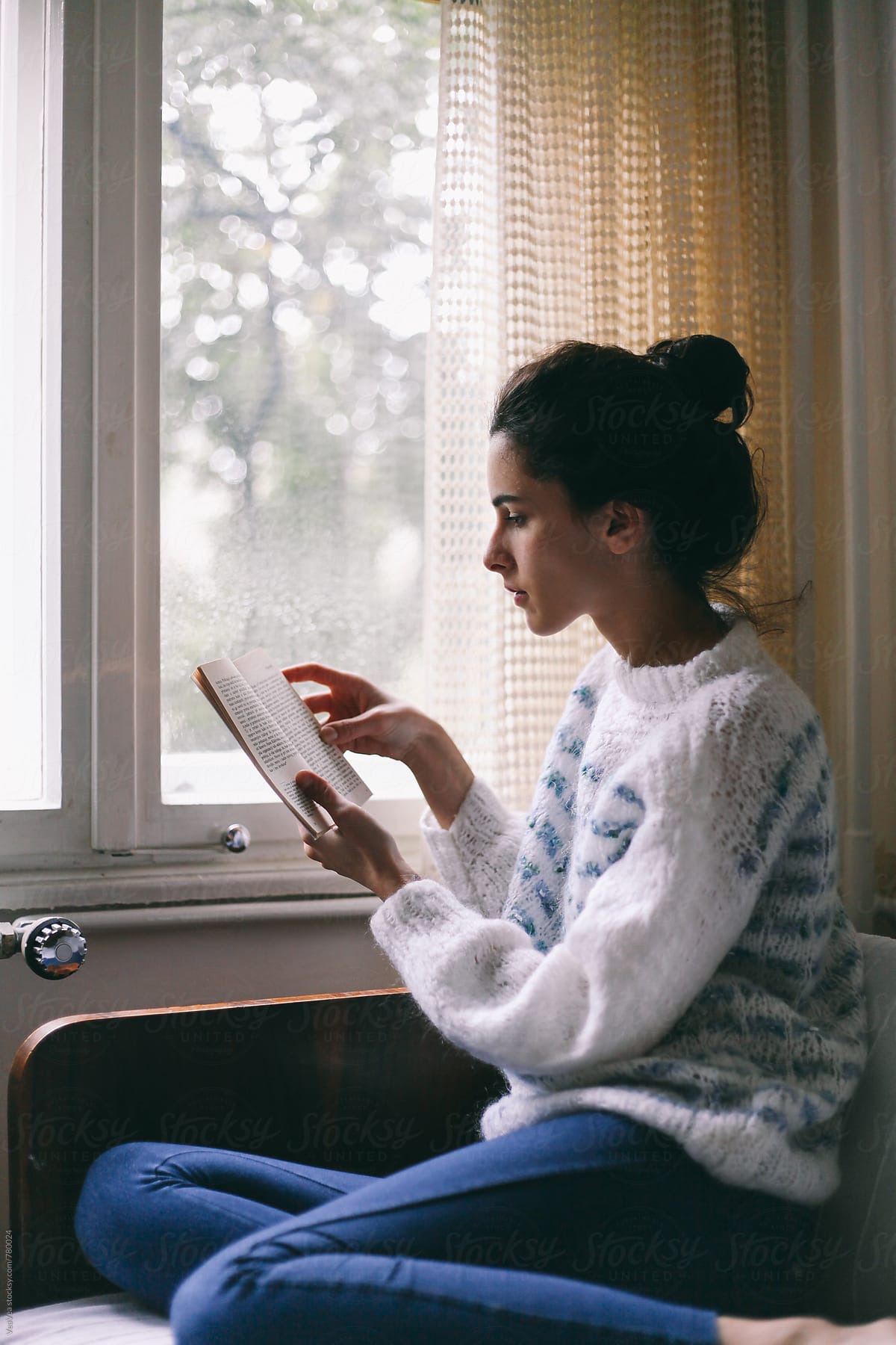 Beautiful Woman Reading A Book In Her Room Near The Window by