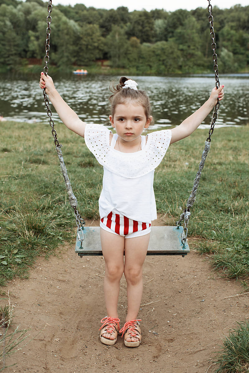 little, cute girl s on a swing