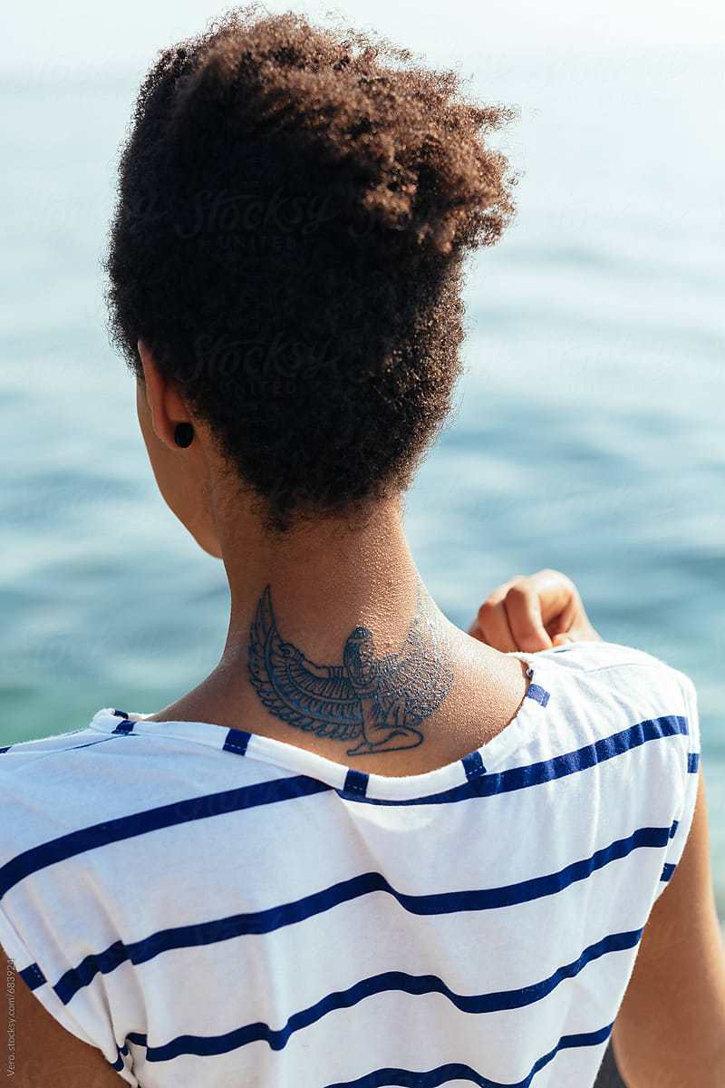 Portrait of a woman with a winged tattoo
