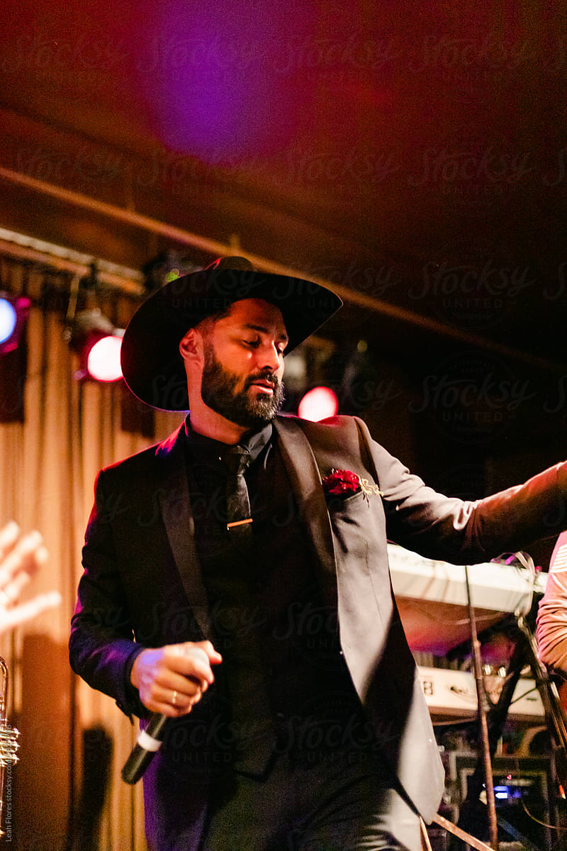 A Groom Holds a Microphone and Performs at his Wedding\'s After-Party