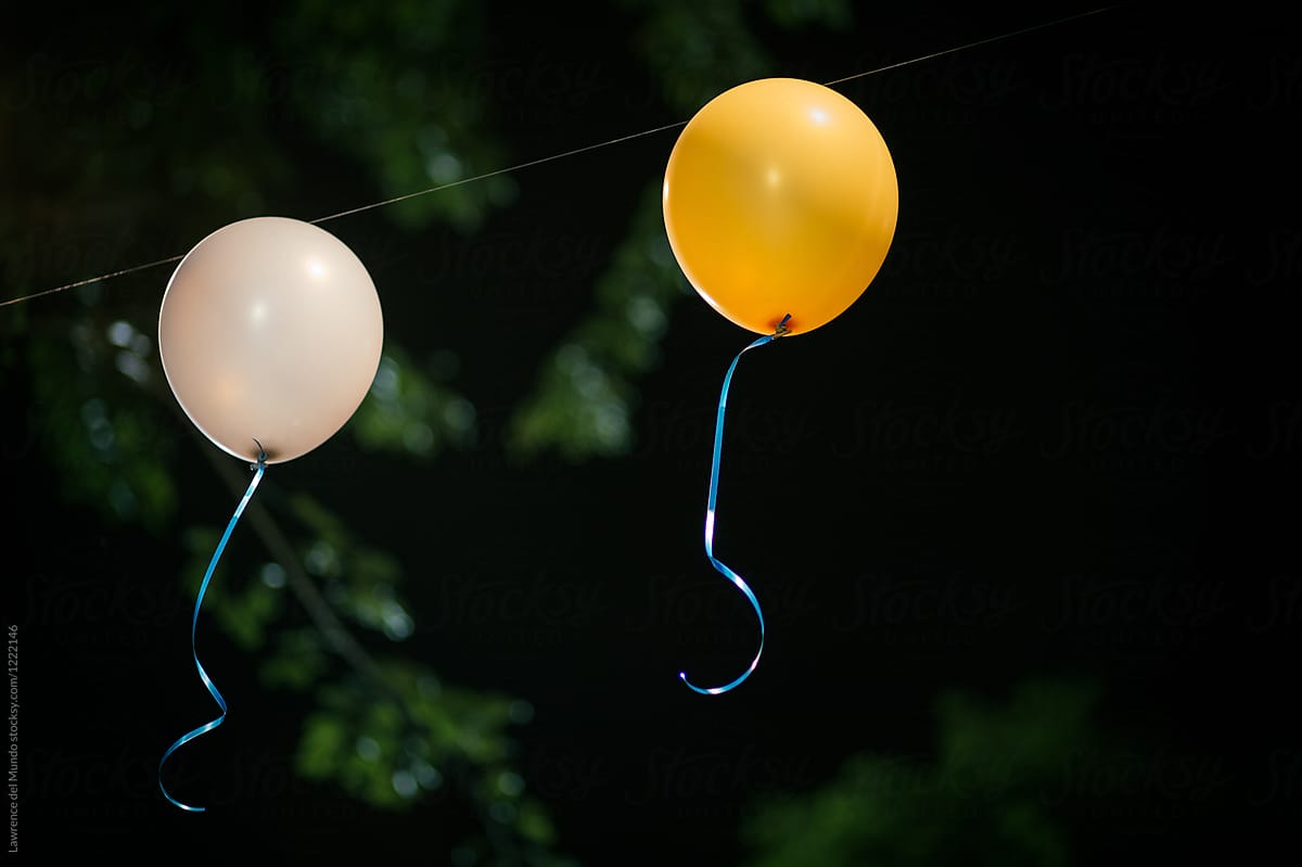 One yellow and one white balloon for party decor.