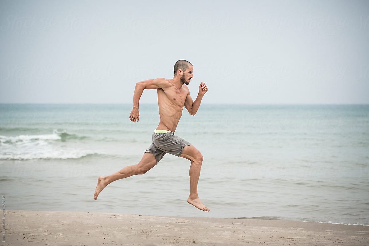 Babe Handsome Athlete Running In The Beach By Stocksy Contributor Lior Lone Stocksy
