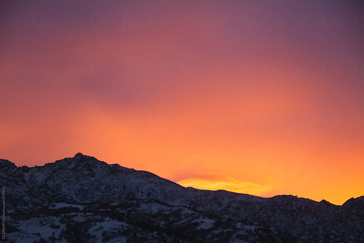 Colorful sunset over snow covered mountains