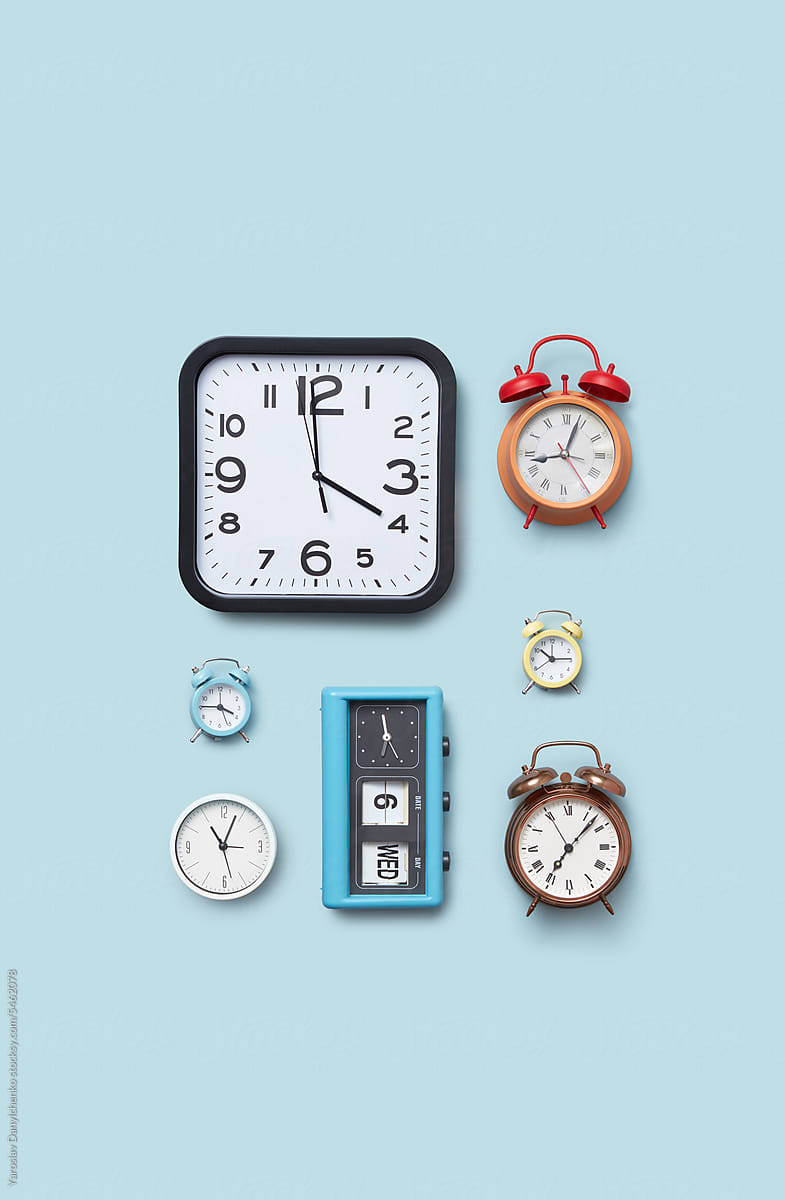 Different types of timepieces: modern, retro and alarm clocks.