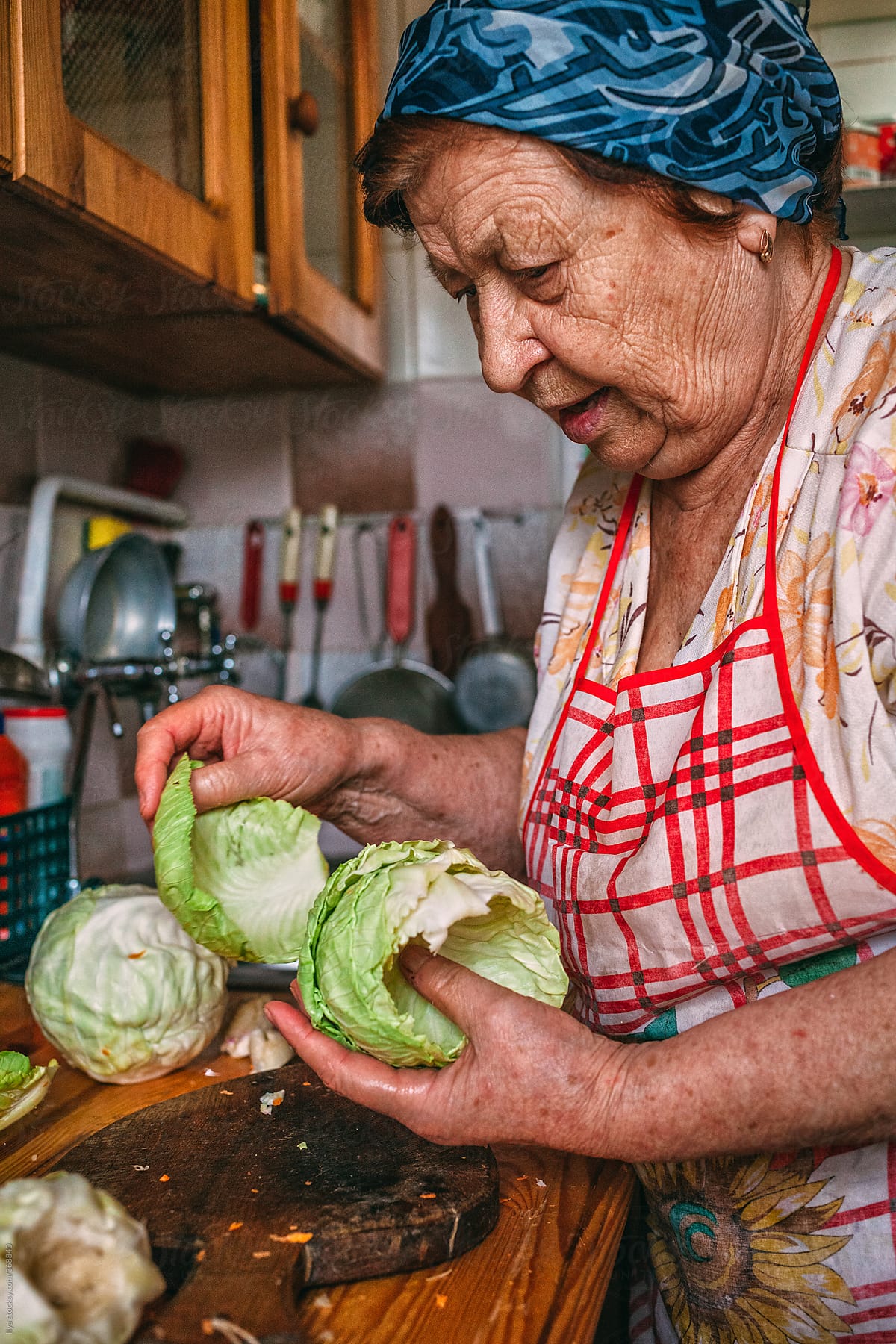 Old woman cooking vegetables