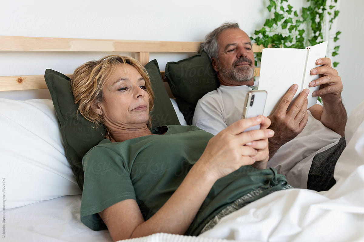 Senior couple relaxing on the bed at home