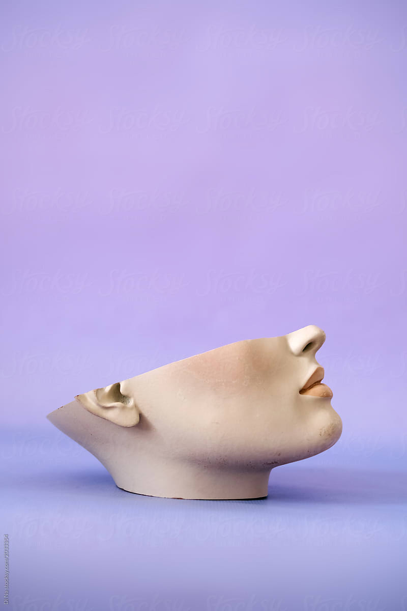 Half of the female dummy face on the purple background