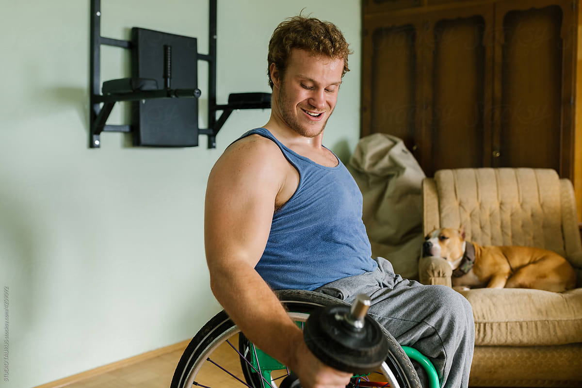 Man In A Wheelchair Working Out At Home