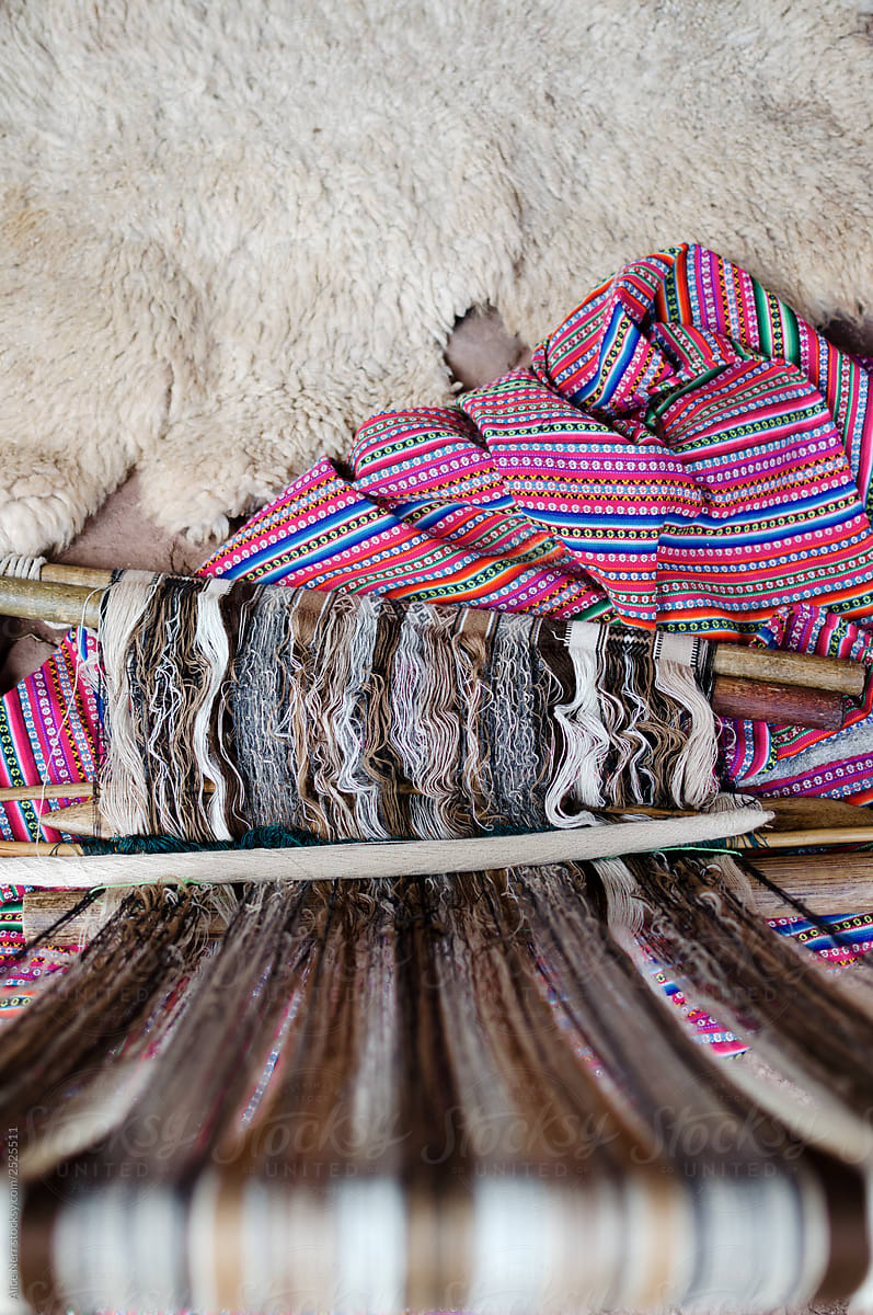 Lama wool on loom next to alpaca skin