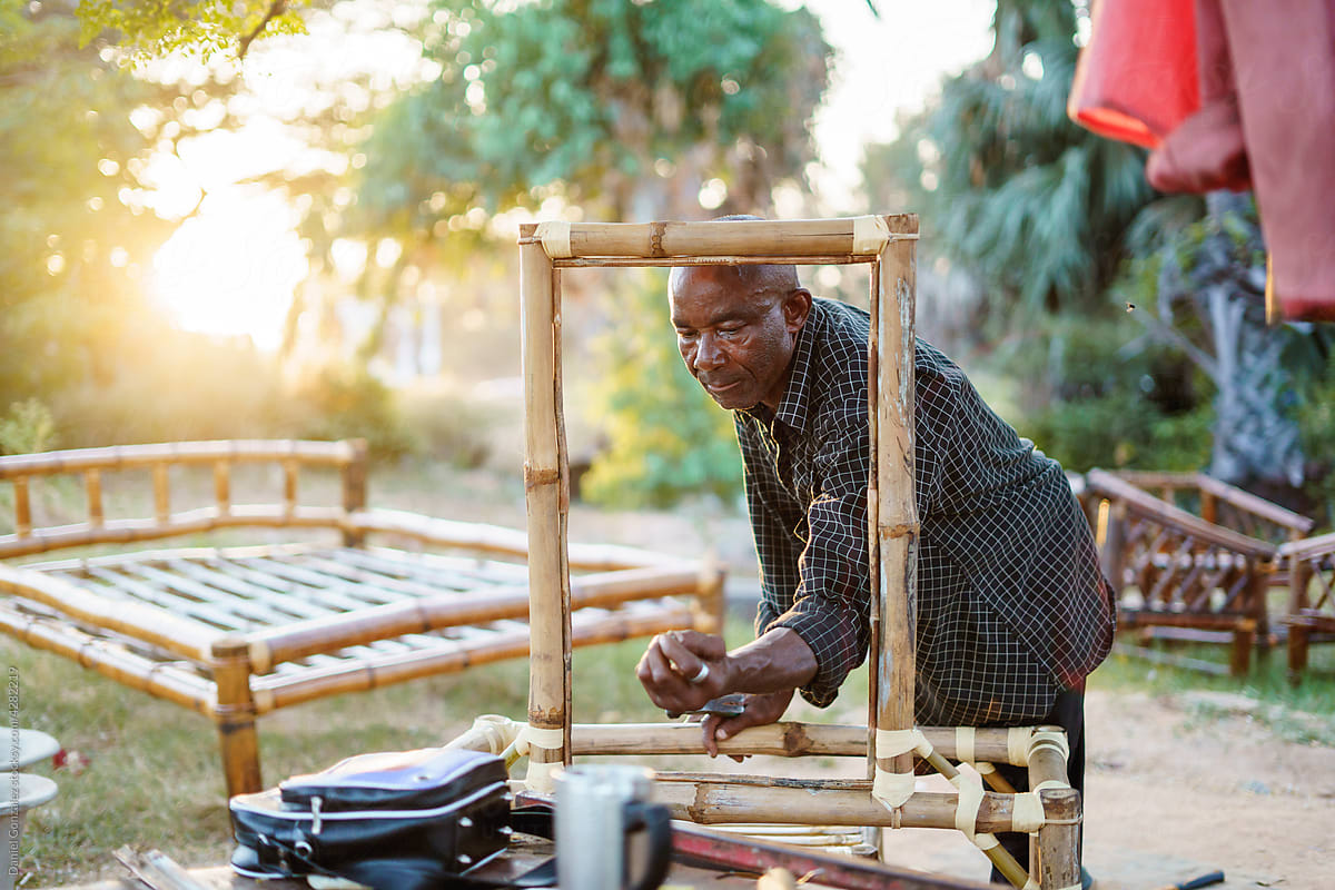 Man making wood furniture in countryside