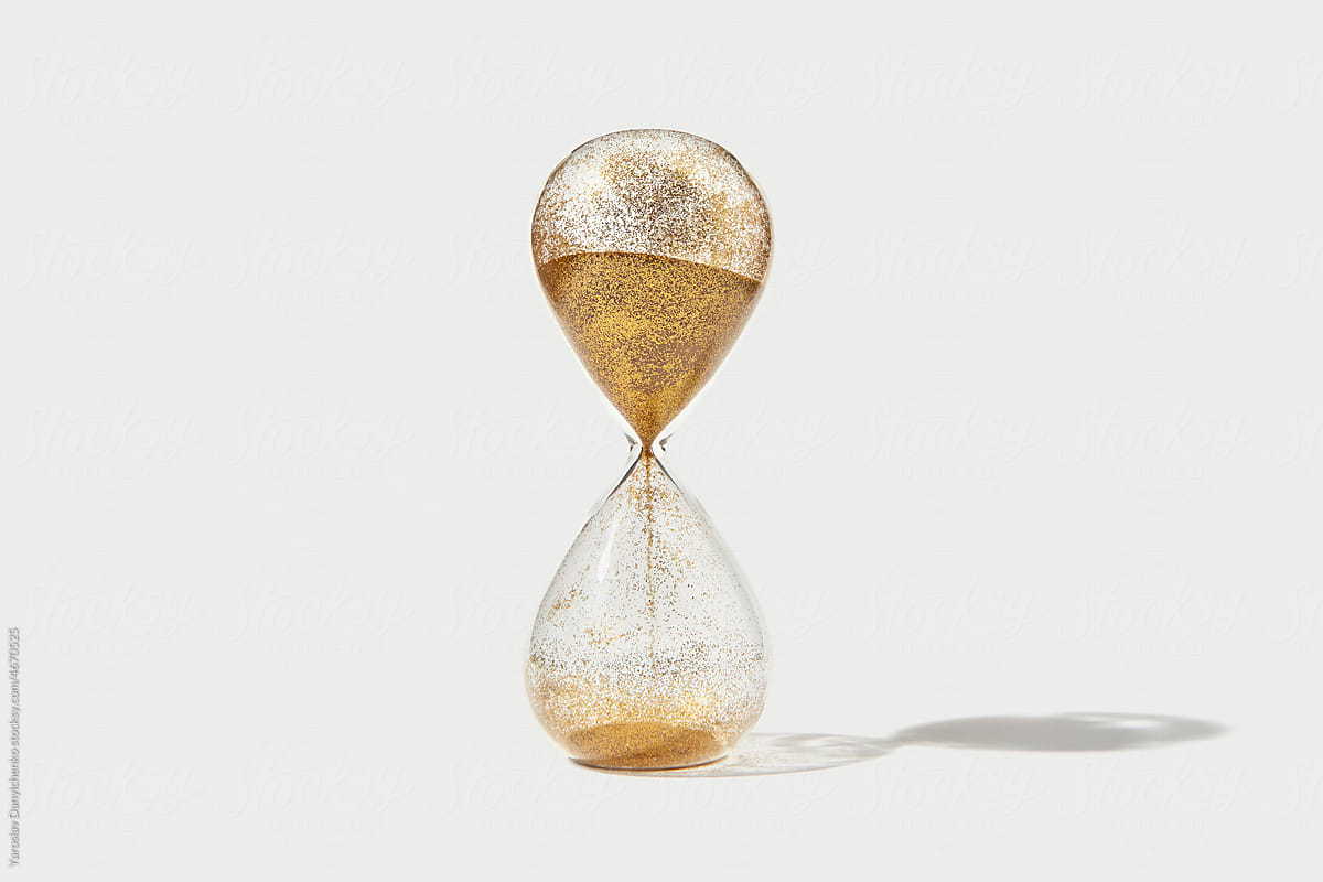 Hourglass with flowing golden sand inside