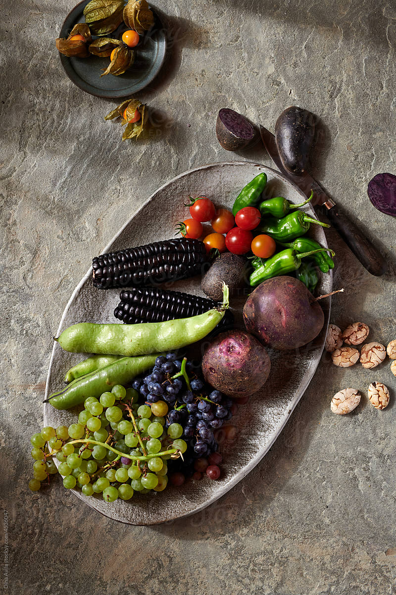 Peruvian Fruit and Vegetables on Stone Plate with Knife