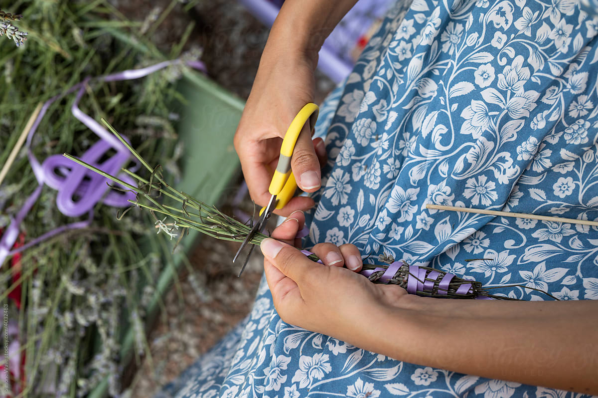 Hands creating lavender craft