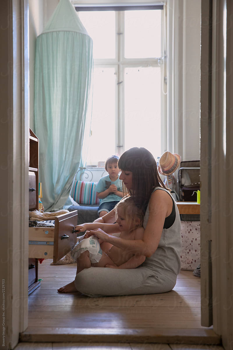 Mother and  two kid in playroom