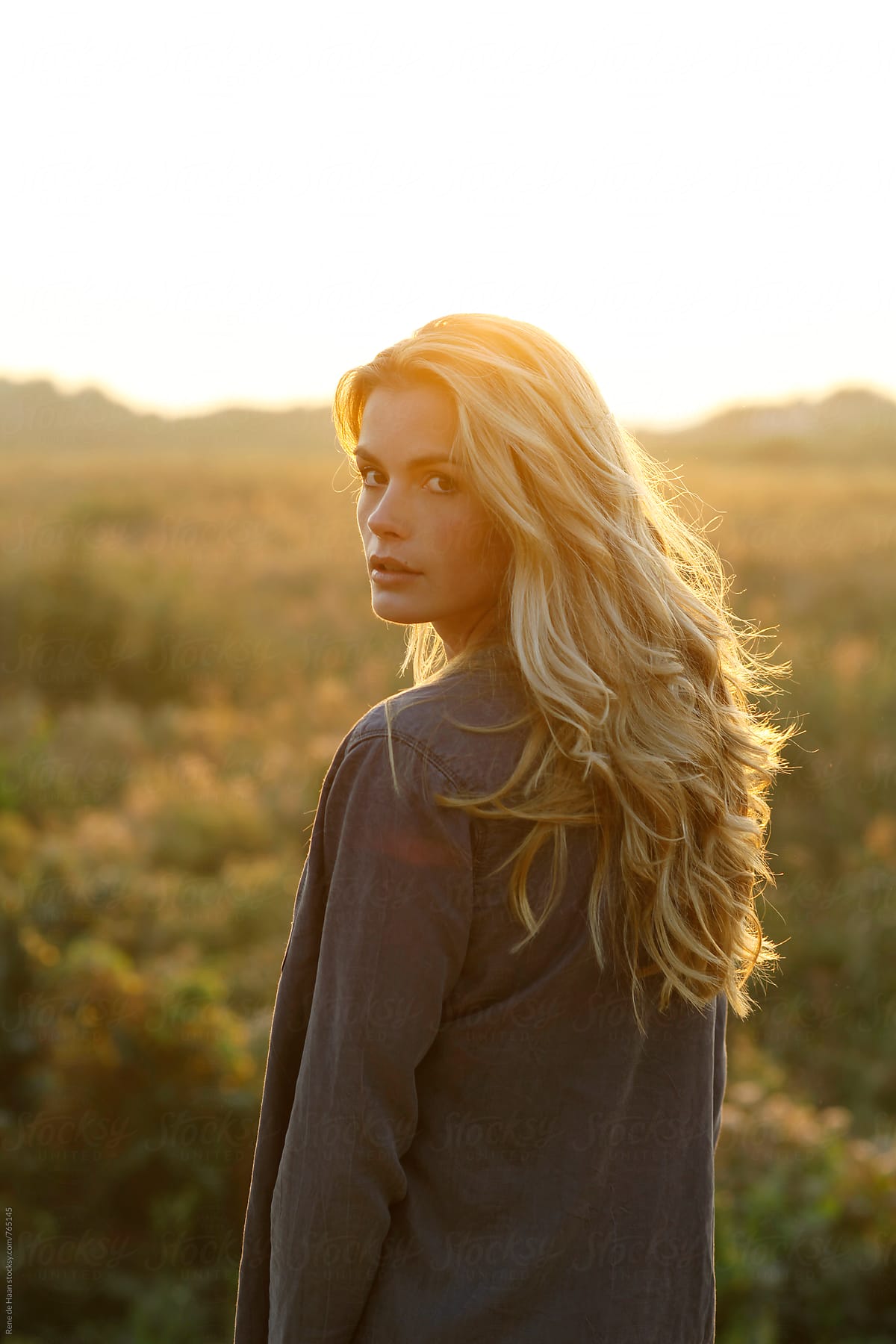 Young Woman With Blonde Hair In Nature At Sunset By Rene De Haan