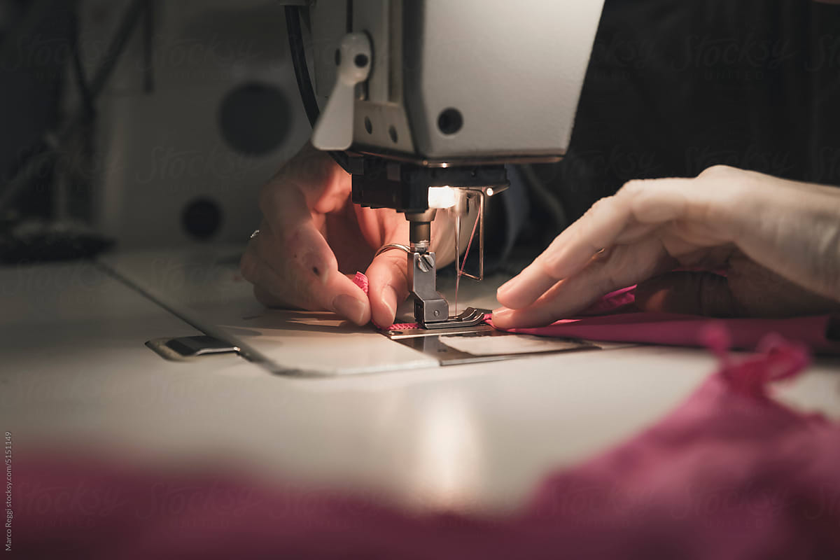 hands sewing a fabric